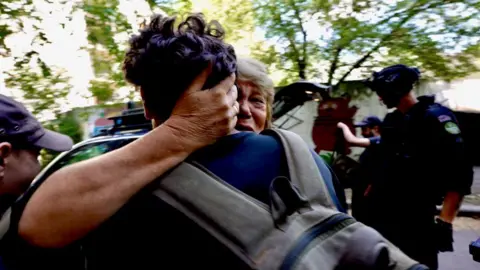 Inside Donetsk as residents flee attacks on Ukrainian region Putin wants to control BBC News A blonde woman, who looks distressed, tightly embraces a man with short brown hair. Her hand is round the back of his head and only the back of his head, back and rucksack can be seen.