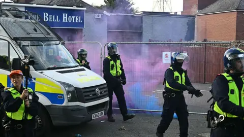 Man told girls in Epping he wanted to 'have a baby', court hears Getty Images Police respond to a protest outside the Bell Hotel in late July. The hotel's entrance can be seen behind a tall, temporary metal fence, outside of which a police van is parked and five uniformed officers are emerging. Red and blue smoke is visible near the hotel's entrance, from flares lit by protesters.