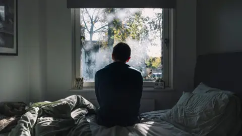 Anger and confusion as Meta overturns more Instagram account bans Getty Images An anonymous man sitting on a bed looking out of the window