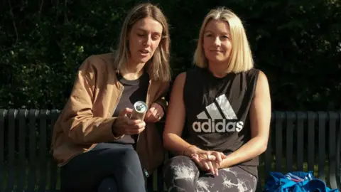 Do wellness drinks really do what they say? Steven Oakes Lucy and Serena sitting on a park bench drinking TRIP