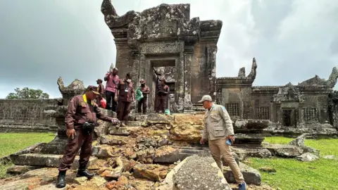 A fierce war of words keeps the two countries on edge Cambodian Mine Action Centre (CMAC) Cambodian officials point to what appears to be broken steps leading up to an old Khmer temple - rubble from broken stones can be seen in the picture.