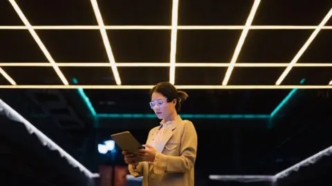 Why the US is taking a cut from China sales Getty Images Young woman wearing augmented reality glasses in a dark environment