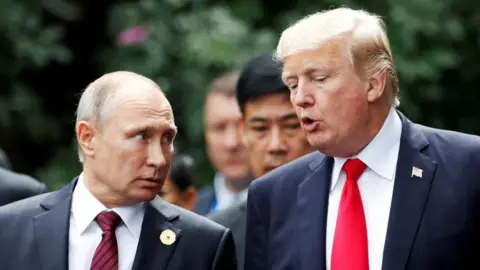 Reuters U.S. President Donald Trump and Russia's President Vladimir Putin talk during the family photo session at the APEC Summit in Danang, Vietnam November 11, 2017