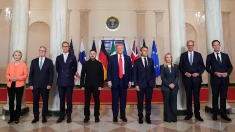 Key takeaways from Ukraine talks in Washington Reuters European leaders, Zelensky and Trump stand to take a traditional 'family photo' in the White House. The seven men and two women stand in front of a row of flags in front of four white marble columns, in a grand room with peach-coloured walls and marble flooring. From left to right, the leaders are: Ursula von der Leyen, Sir Keir Starmer, Alexander Stubb, Volodomyr Zelensky, Donald Trump, Emmanuel Macron, Giorgia Meloni, Friedrich Merz and Mark Rutte.