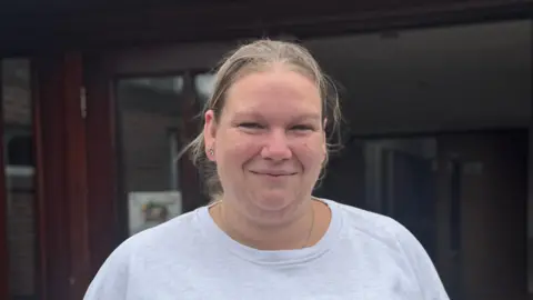 Free school uniform bank in Suffolk 'vital' say parents George King/BBC A head and shoulders picture of Natalie Hull. She is wearing a light grey top and smiling into the camera.
