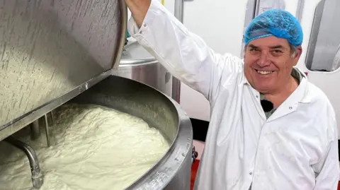 Solar-powered ice cream maker has a record sunny year in Somerset David Baker, wearing a white food production coat and blue hairnet, smiles as he lifts the lid on a steel vat, with frothy milk inside nearly to the top.