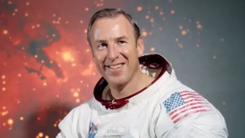 NASA James Lovell is photographed wearing his astronaut suit albeit without his helmet.