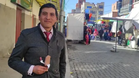 Economic woes dominate as Bolivia prepares to go to the polls Car mechanic Josue Macias holding an ice cream