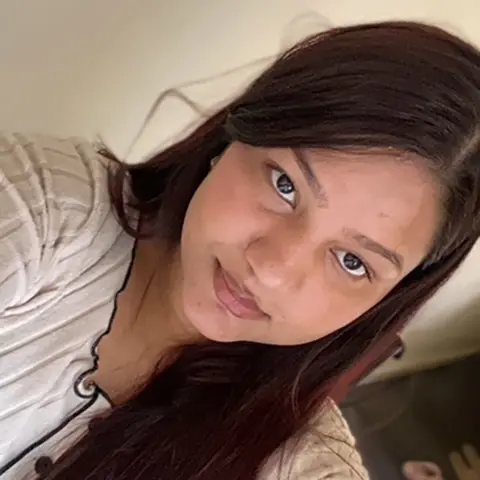 Under-22s join call for free travel Nikita Upreti Nikita Upreti with long straight dark brown hair taking a selfie wearing a cream top with black piping and buttons with a neutral expression on her face