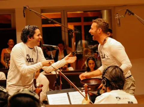 The violinist about to play 10 nights at Wembley with Coldplay Los Angeles Philharmonic Association Gustavo Dudamel and Chris Martin share a joke during rehearsals for the 2016 Super Bowl half-time show