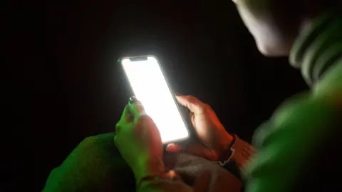 I joined for safety. Then my address was leaked and shared Getty Images/ Carlos Barquero Woman holding phone