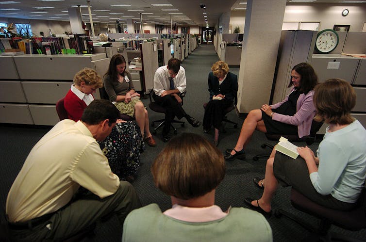 By ‘focusing on the family,’ James Dobson helped propel US evangelicals back into politics Eight adults in business attire sit on chairs in a circle, heads bowed, in the middle of an open-floor office.