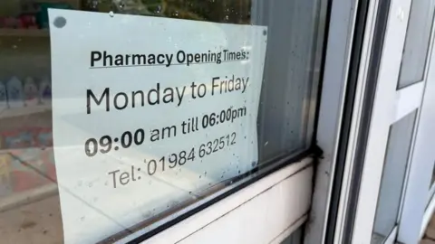 'Shocking' Jhoots pharmacy chain should be shut down, says MP An A4 piece of paper stuck to the inside of a window displays a pharmacy's opening times as 9am to 6pm, Monday to Friday.