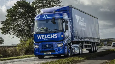 Lack of charging facilities a 'barrier' for electric lorries Welch's Transport A blue Welch's Transport electric heavy goods vehicle driving down a main road in the countryside
