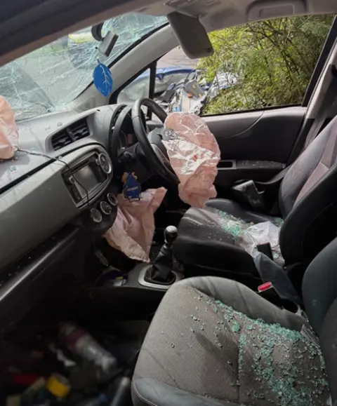 The six things you should do if you're in a crash Rebecca Mason Inside of a car after a collision with glass on the seat and airbags