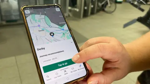 Ticketless train travel to be trialled across Derby, Leicester and Nottingham BBC A close-up of the new app being used on a mobile at a train station