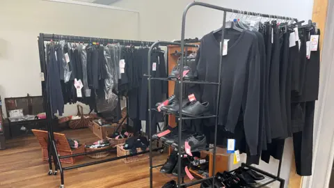 'Less of a stigma' on second-hand school uniforms school uniforms hanging in a room