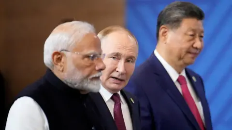 How oil has brought China, Russia and India closer together Reuters Modi, Putin and Xi standing in a row wearing dark suits or vests