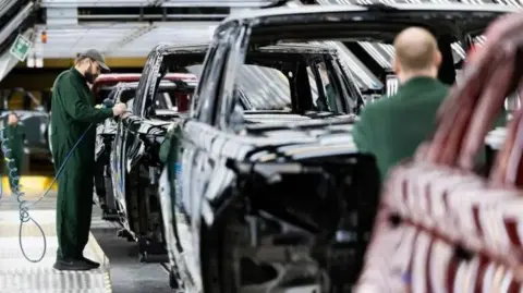 Labour must step up to help JLR supply chain jobs, says Unite Getty Images An employee where dark green overalls and a cap polishes paint on the bodywork of a Range Rover sports utility vehicle (SUV) in the paint shop at Jaguar Land Rover vehicle manufacturing plant in Solihull, UK.