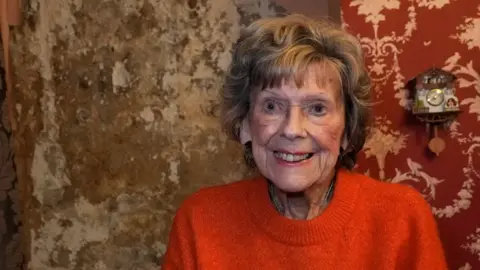 30,000 homes fitted with botched insulation under government schemes, ministers admit Margaret Chappell a 93-year-old woman whose bright smile and immaculate appearance with neatly permed light brown hair and tasteful make-up contrasts with the wall behind her which is consumed by brown mould with plaster peeling off it.