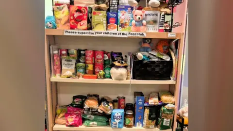 Cambridgeshire Send charity 'supported 8,000 people' in 'August Little Miracles Shelves of food items including boxes of soup, tins and jars placed next to each other.