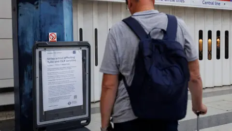 Londoners without Underground service during walkout EPA A man stands with his back to the camera looking at an information board. In front of him is the shuttered entrance to a Tube stations.