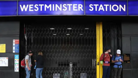 London Tube strike enters third day with more disruption reported EPA Westminster Tube station with its shutter closed and people standing outside it.