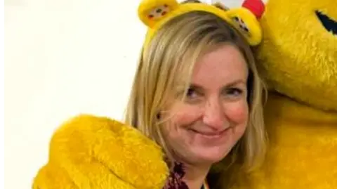 Cambridgeshire Send charity 'supported 8,000 people' in 'August Louise Evans Louise wearing a floral burgundy top and yellow Pudsey head band smiling for the camera.