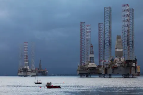 Net-zero 'not a platitude' for oil and gas sector Getty Images Rigs stacked up on the Cromarty Firth.