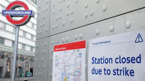 All you need to know Reuters A station closed sign attached to a wall in front of an Underground station, with another sign giving details of buses from Victoria next to it