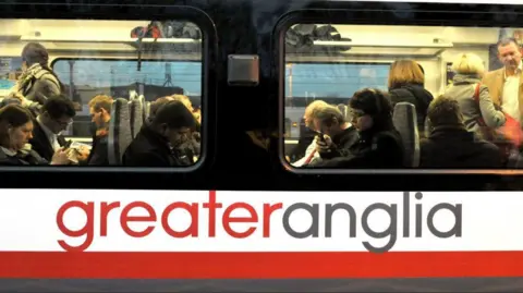 PA Media A Greater Anglia train full of passengers