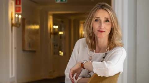 Can the plastic recycling industry be saved? Plastics Europe Wearing a white top, Virginia Janssens leans her arm on the back of her chair as she turns to face the camera.