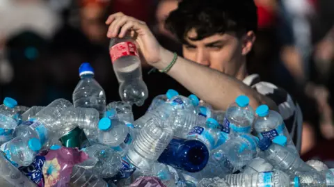 Can the plastic recycling industry be saved? Getty Images A man adds an empty plastic bottle to a large pile of plastic bottles.