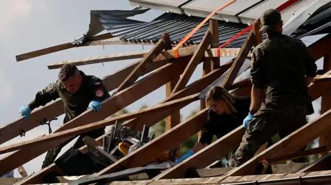 What's the best way to detect and destroy drones? AFP via Getty Images In Poland in September, three people inspect a damaged roof, where the wooden beams have been exposed. The roof was hit by falling parts of a drone that had been shot down.