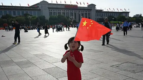 How China's Five Year Plans have changed the world AFP via Getty Images A child plays holds the national flag in Tiananmen Square on China's National Day, which marks the 76th anniversary of the founding of the People's Republic of China, in Beijing on October 1, 2025.