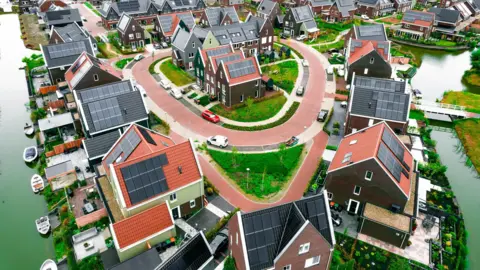 Netherland's renewables drive putting pressure on its power grid AFP via Getty Images Dutch homes covered in solar panels