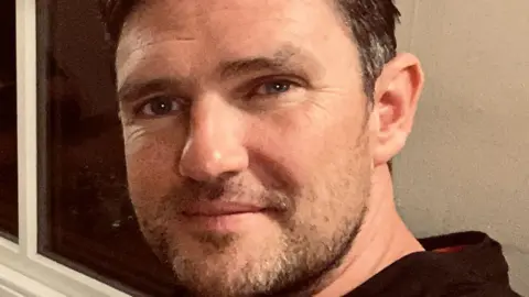 MoJ owes us £20m after contractor ISG's collapse, say suppliers Dan Henshaw Dan Henshaw in a selfie. He has brown greying hair and a patchy beard. He is a white man. He looks to be in a living room or somewhere at home.