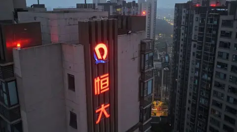 China's economic growth slows as trade tensions with US flare up Getty Images Aerial view of a China Evergrande property development in Nanjing, China on the early morning.