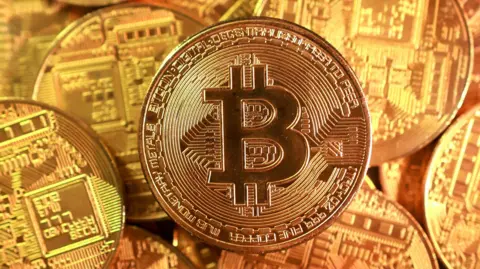 Reuters Gold coloured representations of Bitcoin coins.
