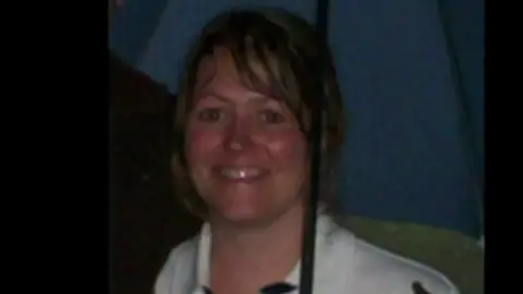 Horizon sub-postmasters call for retrial in Post Office murder case Family handout Diana Garbutt pictured smiling holding an umbrella