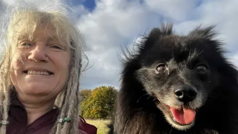 Pet owners say they are forced to cut back on food to afford vet bills Dee Terry A close up selfie of Dee with her dog Bilbo. Dee has white blonde hair with dreadlocks. Next to her is Bilbo, a small black dog which smiles at the camera. He has fine, straight black hair and dark brown eyes. They're sat in a field whilst on a dog walk.