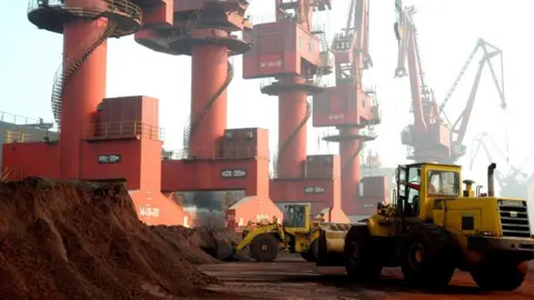 China has found Trump's pain point Reuters Two yellow trucks move heaps of soil containing rare earth elements at a port in China. At least five red cranes in the background tower above the trucks.