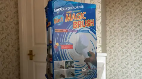 Mum's warning after Temu brush rips out child's hair The blue box features a clear image of the product on the front, showcasing its brush. Prominently displayed is the label “5-in-1”,. over this  this, the tagline reads: “Electrically Driven, Care Free”