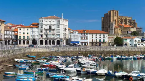 Tim Graham/Getty Images The church of Santa María de la Asunción overlooks the fishing harbour of Castro Urdiales in northern Spain. Moored fishing boats can be seen in the foreground while quayside buildings and the church can be seen in the background.