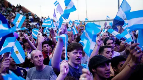 The US bet big on Argentina bailout Getty Images Supporters of President of Argentina Javier Milei wave Argentine flags waiting for his arrival at a closing campaign rally ahead the mid-term election on October 23, 2025 in Rosario, Argentina