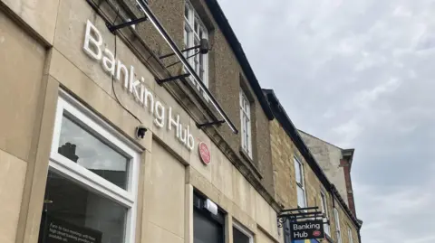 The new hubs saving Yorkshire towns from becoming banking deserts Kit Taylor/BBC A stone building with white lettering saying 'Banking Hub'