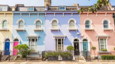 Five ways abolishing the tax could change the housing market Getty Images A row of terraced houses painted, left to right, yellow, blue, purple and pink, with fences and shrubs in front.