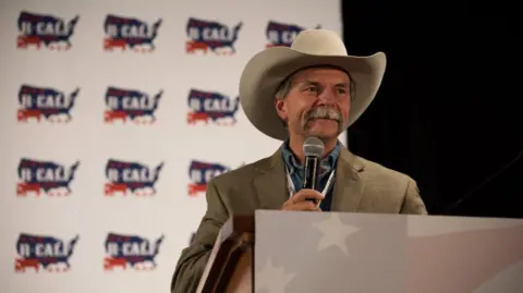 US beef prices are soaring. Will Trump's plans lower them? Bill Bullard A man wearing a cowboy hat speaks into a microphone.