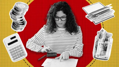 BBC A woman with curly dark hair and glasses wearing a striped top calculating bills, with coins, a money jar, a calculator and a book surrounding her. 