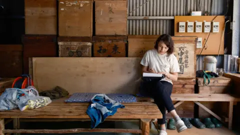 Mizuba Tea Lauren Purvis of Mizuba Tea Co works on paperwork at a sencha factory in Japan 